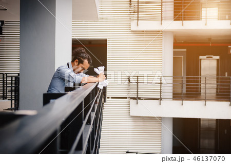 Businessman standing on balcony office room 46137070