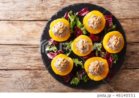 Delicious appetizer peaches stuffed with tuna 46140551