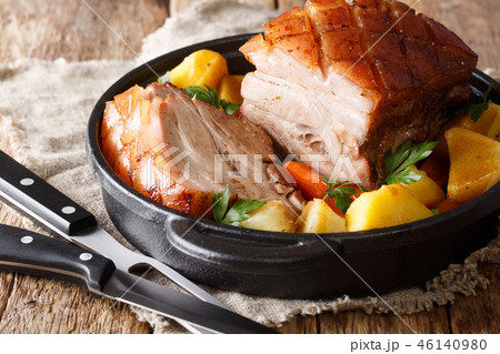 Tasty crispy pork baked in beer with vegetables 46140980