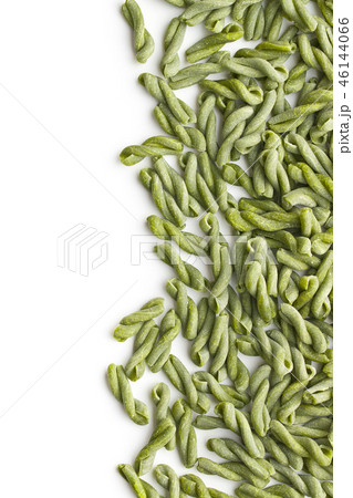 Uncooked spinach gemelli pasta. 46144066