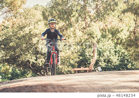 Boy riding his bicycle 46148234