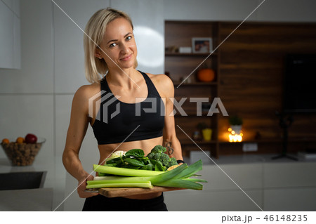 a sporty girl with set of green vegetables 46148235