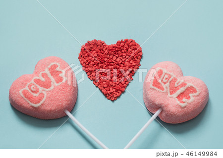 Couple valentine pink lollipops on pastel blue.  46149984