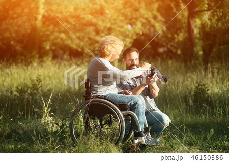 Disabled woman look on the taken photos on camera. Disabled woman look on the taken photos on camera. 46150386