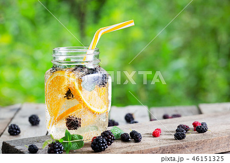Cocktail lemonade from orange and berries in mason jar 46151325