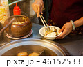 A woman serves stinky tofu at the night market 46152533
