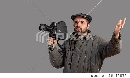 Emotional cameraman with retro camera, studio shot Emotional cameraman with retro camera, studio shot 46152832