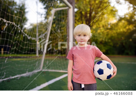 Boy having fun playing a soccer/football game Boy having fun playing a soccer/football game 46166088