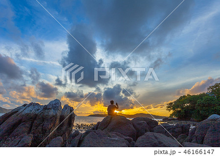 a man selfie on the rock at sunrise 46166147