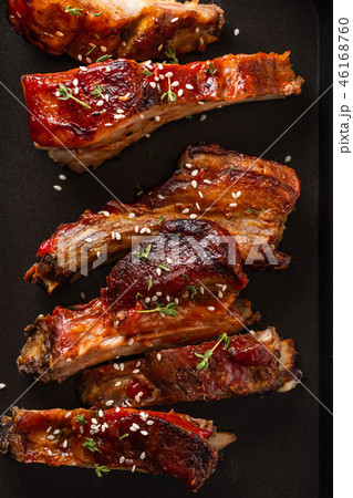 Delicious barbecued ribs seasoned with a spicy basting sauce. lose-up, copy space. 46168760