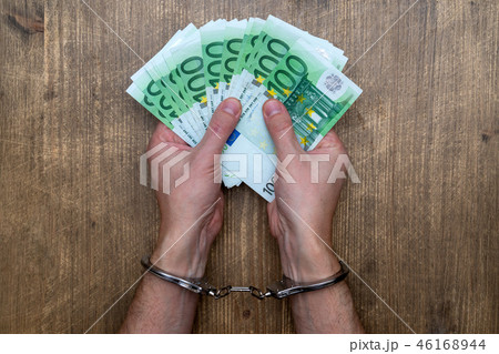 Hands in handcuffs with money Hands in handcuffs with money 46168944