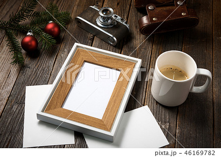 Photos, camera, pine tree branch and cup of coffee Photos, camera, pine tree branch and cup of coffee 46169782