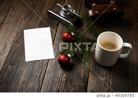 Photos, camera, pine tree branch and cup of coffee Photos, camera, pine tree branch and cup of coffee 46169783