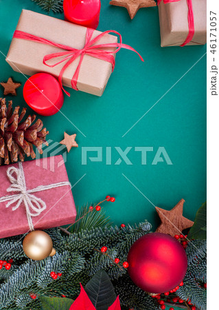 Christmas composition. Christmas green decorations, fir tree branches with toys gift boxes on green 46171057