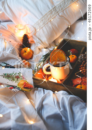 Christmas background dry oranges, sweet tangerines in a box, coffee in a white mug. Christmas background dry oranges, sweet tangerines in a box, coffee in a white mug. 46172069