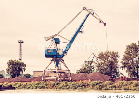 Blue crane in cargo port, red filter 46172350