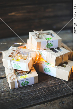 Christmas - a group of gifts on the background of garlands. close-up Christmas - a group of gifts on the background of garlands. close-up 46172415