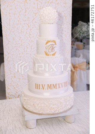 Beautiful wedding white cake in restaurant. inside Beautiful wedding white cake in restaurant. inside 46172751