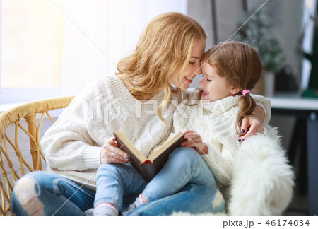 happy family mother reads book to child  46174034