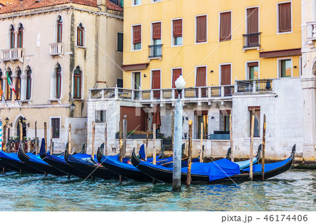 Gondolas moored in front of the terrace of a venetian palace on Gondolas moored in front of the terrace of a venetian palace on 46174406