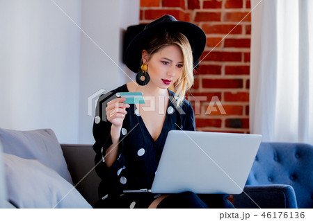 Young girl with laptop computer and credit card Young girl with laptop computer and credit card 46176136