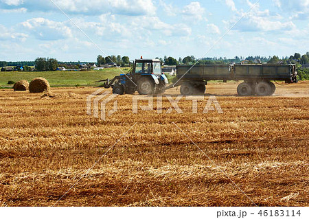 tractor removes haystacks in a tractor removes haystacks in a 46183114