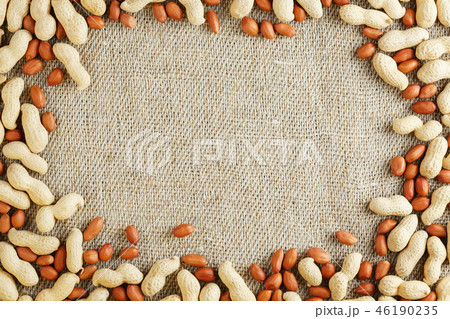 Roasted peanuts in a shell and peeled on a brown  46190235