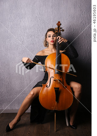 Beautiful woman in evening dress playing the celloの写真素材