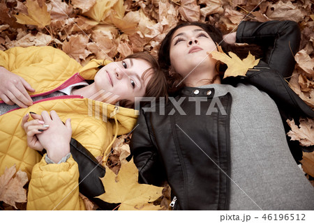 Pretty woman and teen girl are in autumn park Pretty woman and teen girl are in autumn park 46196512