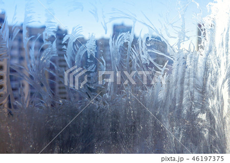 Frozen winter window with shiny ice frost pattern texture 46197375