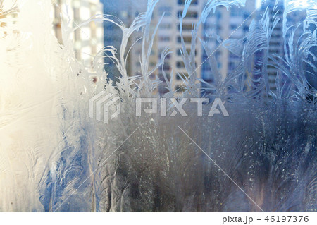 Frozen winter window with shiny ice frost pattern texture Frozen winter window with shiny ice frost pattern texture 46197376