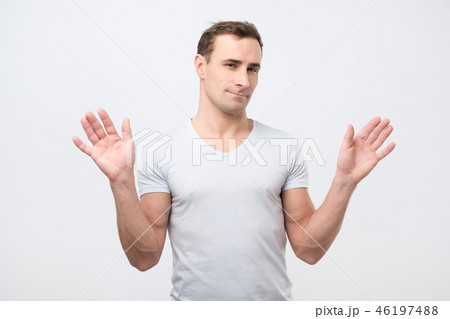 italian man in pink shirt is unsure 46197488