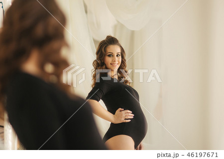 Morning of young pregnant woman dressed in black bodysuit. Happy future mother 46197671