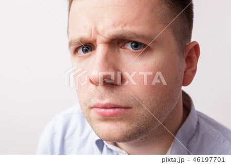 Young man frowned angrily looks into the camera Young man frowned angrily looks into the camera 46197701