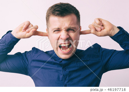 man stops his ears with fingers 46197718