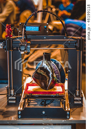 3D printer printing a model in the form of black vase close-up. 3D printer printing a model in the form of black vase close-up. 46199118