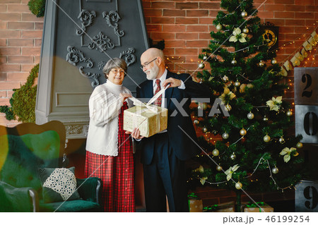 An elegant old couple are celebrating Christmas An elegant old couple are celebrating Christmas 46199254