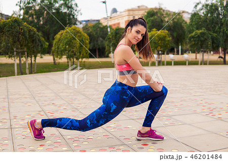 Runner fit woman warming up before sport training in the park Runner fit woman warming up before sport training in the park 46201484