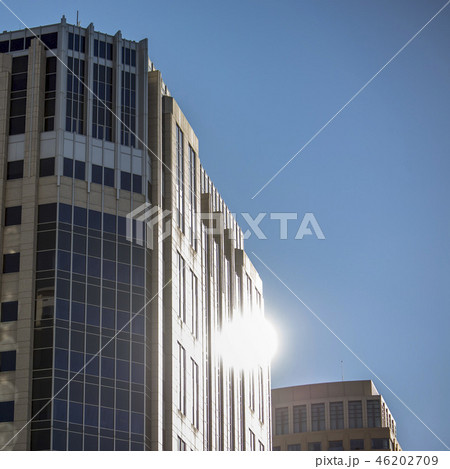 Blue glass building with reflection of the sun 46202709