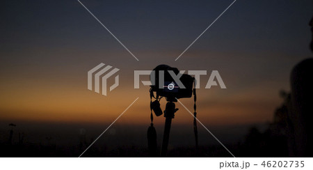 A photographer camera overlooking horizon at dusk 46202735