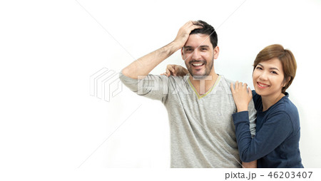 Happy young Couple standing over white wall. Happy young Couple standing over white wall. 46203407