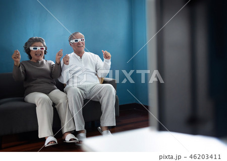 Cheerful Asian Senior Couple wearing 3D glasses. 46203411