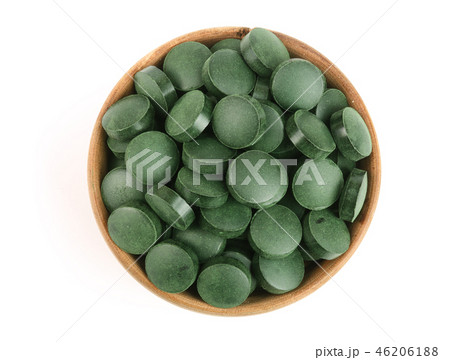 heap of Spirulina tablets algae nutritional supplement in wooden bowl isolated on white background heap of Spirulina tablets algae nutritional supplement in wooden bowl isolated on white background 46206188