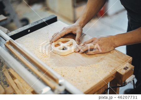 The carpenter works with a tree 46207731