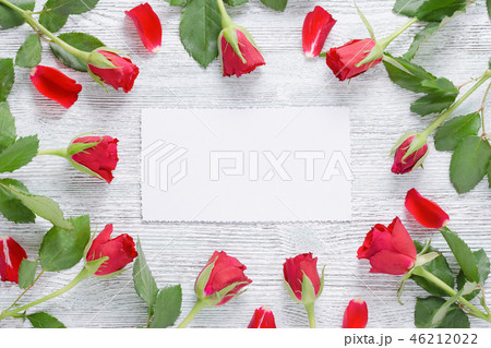 frame with red roses and white card for text on the vintage wooden background frame with red roses and white card for text on the vintage wooden background 46212022