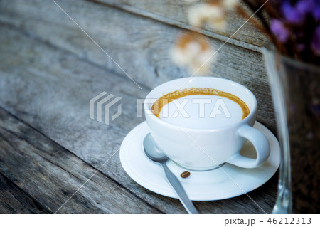 Coffee cup and vase on table. Coffee cup and vase on table. 46212313