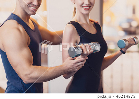 Happy girl doing strength exercise dumbbell hands 46214875