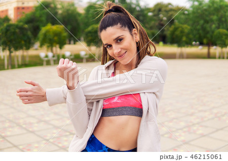 Runner fit woman warming up before sport training in the park Runner fit woman warming up before sport training in the park 46215061