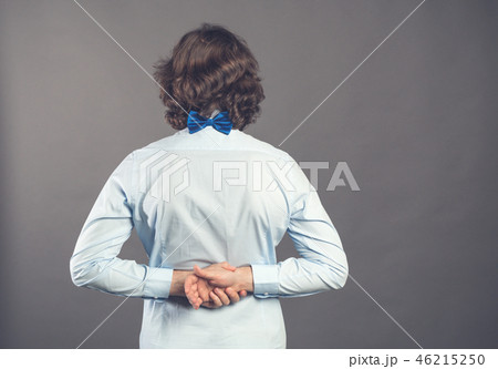 Back view of man in blue shirt and bow tie. Standing young guy. Rear view people collection 46215250