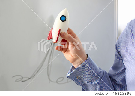 Businessman in suit hold white rockrt in hand 46215396